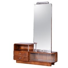 a wooden dresser with a mirror on top of it and drawers under the shelf next to it