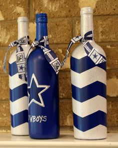 two blue and white striped bottles are sitting on a shelf next to a brick wall