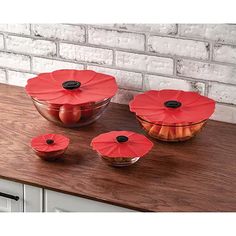 three bowls filled with food on top of a wooden counter