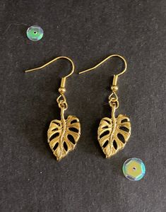 Pair of handmade gold monstera leaf earrings.  These earrings are made from gold monstera leaf shapes and they have gold colour hook fastenings. The drop measures 4cm and they are 1.5cm wide. They are hand made by me. These earrings would make a great gift! All purchases of jewellery or hair accessories come with a free lilac organza gift bag! I currently only post within the UK, Canada, USA and the European Union. Postage for additional items purchased in the same transaction is free, so please Dangly Gold Earrings, Gold Monstera Leaf, Leaf Earrings Gold, Monstera Leaf Earrings, Gold Foliage, Gold Leaf Earrings, Gold Colour, European Union, Monstera Leaf