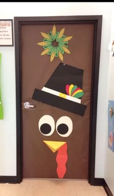 a door decorated to look like a turkey with a top hat on it's head