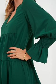 Meet one of our favorite silhouettes, the Crepe Kenzo Dress. Featuring feminine flutter smocked cuffs, a V-neckline, and a loose empire waist, this is the most flattering flirty frock! Pair this hunter green stunner with flats for a casual look or dress up with heels and statement earrings for date night. V-neckline Long sleeves Elasticated ruffle cuff Loose empire waist Tiered skirt Swing shape Mini length Crepe fabric Material: 97% Polyester, 3% Spandex Care: Machine wash cold Kenzo Dress, Plus And Minus, Tier Skirt, Crepe Fabric, Tiered Skirt, Hunter Green, Empire Waist, Fabric Material, Statement Earrings