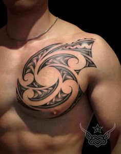 a man's chest with an intricate tattoo design on his chest and chest area