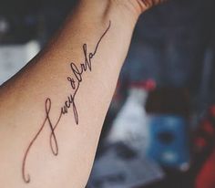 a woman's arm with a tattoo that reads, happy new year on it