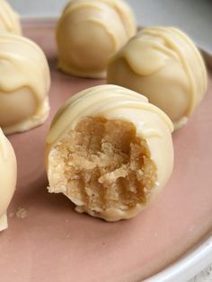 some white chocolates are on a pink plate