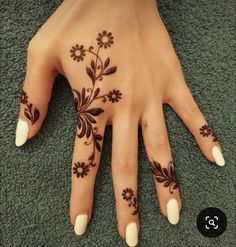 a woman's hand with black and white flowers on it