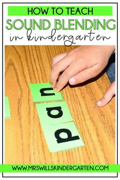 a child's hand on top of a wooden table with the words sound blending in black