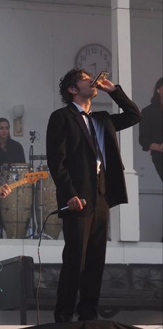 a man in a suit singing into a microphone