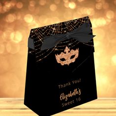 a black and gold thank you card with a masquerade mask on the front