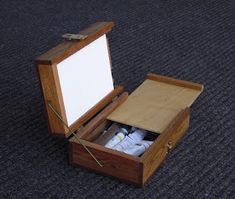 an open wooden box on the ground