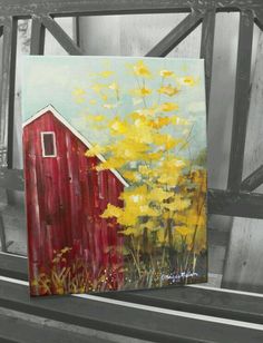 a painting of a red barn and yellow flowers on a wooden bench in black and white