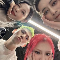 four young women with different colored hair and piercings