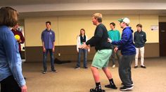 a group of people standing in a room with one person holding a frisbee