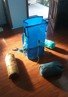 a blue bag sitting on top of a wooden floor