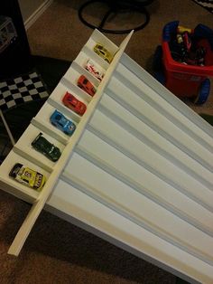 the toy cars are lined up on top of each other in this playroom area