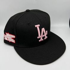 the los angeles dodgers baseball cap is black and has pink embroidery on it's side