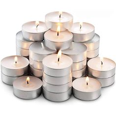 a stack of white candles sitting on top of each other in front of a white background