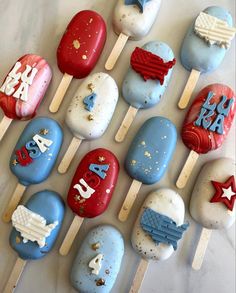 an assortment of cake pops decorated in the colors of the american flag