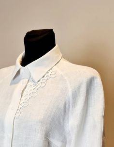 "Blouse of a semi-adjacent silhouette.  Chest darts on the front.  Back with middle seam.  Raglan sleeve with top seam, long, widened to the bottom, with a wide cuff, fastened with 2 buttons.  The neck is finished with a stand-up collar on a cut-off stand.  Central fastener with six loops and buttons.  Optionally, the model can be decorated with white or black lace on the left half of the front and on the cuff. SIZE CHART: SIZE XS (mostly USA/CA-2, UK-4, AU/NZ-6, JAP-5, EU-32) Bust/Waist/Hips 80cm/60cm/88cm 31.5\"/25.2\"/34.5\" SIZE XS/S (mostly USA/CA-4, UK-6, AU/NZ-8, JAP-7, EU-34) Bust/Waist/Hips 84cm/64 cm/92cm 33\"/26.5\"/36.2\" SIZE S (mostly USA/CA-6, UK-8, AU/NZ-10, JAP-9, EU-36) Bust/Waist/Hips 88cm/68cm/96cm 34.5\"/28.5\"/37.7\" SIZE M (mostly USA/CA-8, UK-10, AU/NZ-12, JAP-11, E Elegant White Linen Shirt, Elegant Summer Blouse With Set-in Sleeves, Casual Fitted Blouse With Lace Sleeves, Summer Workwear Blouse With Lace Sleeves, Chic White Blouse With Lace Sleeves, Elegant Fitted Tops With Embroidered Sleeves, Casual Short Sleeve Blouse With Lace Sleeves, Summer Blouse With Lace Sleeves And Short Sleeve, Summer Blouse With Short Lace Sleeves