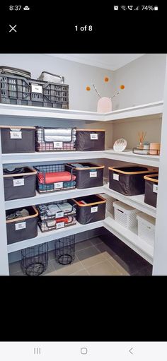 an image of a closet with bins and boxes on the bottom shelf for storage