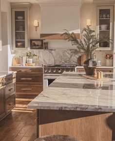 a kitchen with marble counter tops and wooden cabinets