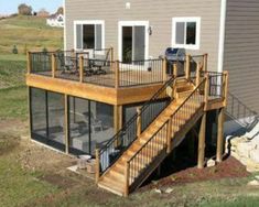 a house with a deck and stairs leading up to it