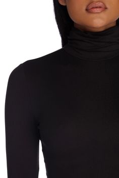 This essential trendy turtle neck crop top is a must-have for your closet! It features a funnel turtle neck. long fitted sleeves. and a cropped hem. The black top is composed of a brushed knit fabric with plenty of stretch.Model is 5'8" with a 32" bust. 23" waist and 36" hips. She is wearing a size small.