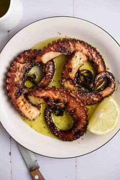 octopus rings with olives and lemon on a plate