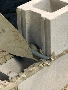 a cement block being worked on with a trowel