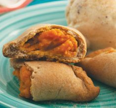 some food is on a blue plate and it looks like they have been rolled up