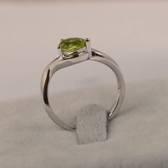 ~~~~~~~~~~~~~~~~Ring details~~~~~~~~~~~~~~~~metal: silver/14k white(rose/yellow) goldcenter stone: oval shape 6*8mm (1.40ct) peridotaccent stone: noneNOTE: if it is silver or white gold, it will be get plated with rhodium~~~~~~~~~~~~~~~~Customization is available~~~~~~~~~~~~~~~~you can change, add or remove any parts of the ring if you have good idea. I can add special engraving inside the shank of the ring by free (words, date, simply simbles and so on) too. I am happy to help out or make any a Silver Solitaire Engagement Ring, August Birthstone Ring, Green Sapphire Ring, September Birthstone Rings, Engagement Ring For Women, Peridot Stone, August Birthstone, Sterling Silver Engagement Rings, Peridot Ring