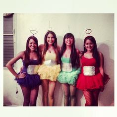 four girls dressed up in costumes posing for the camera with their hands on their hipss