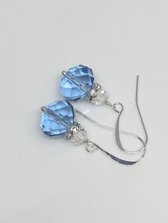 "12x10mm Light blue sapphire faceted crystal glass silver plated brass earrings the length with the hook is 1.25\". Hand made jewelry! All purchase will arrive in gifts boxes. Thanks for stopping by!" Nickel-free Blue Crystal Earrings For Formal Occasions, Elegant Blue Crystal Earrings With Faceted Beads, Blue Sterling Silver Earrings With French Hook, Sterling Silver Blue French Hook Earrings, Nickel Free Blue Crystal Earrings, Nickel-free Blue Crystal Earrings, Blue Crystal Earrings With Ear Wire For Formal Occasions, Blue French Hook Jewelry As Gift, Blue Czech Glass Crystal Earrings With Ear Wire