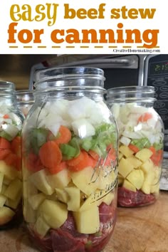 four mason jars filled with food sitting on top of a wooden table