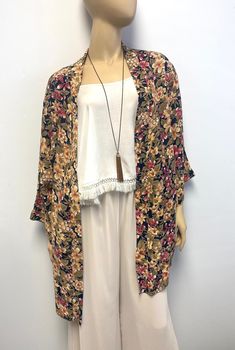 Love this fun, handmade, opaque Kimono duster.  Background black surrounded by playful red, olive and gold flowers. You can create a polished, sophisticated look for a dressy event, such as a bridal party or  holiday brunch.   This also makes a great gift for Mommy To Be. A beauty she can wear before, during and after  Rayon crepe. Hand wash, dry flat or Dry clean. Available now in Size 2 Shoulder to shoulder:  20" Bust:  Up to 50" circumference, Open front--no closure, (25" lying flat) Hips:  U Floral Print Kimono Sleeves Outerwear For Festival, Floral Kimono Sleeve Outerwear For Festivals, Long Floral Print Kimono For Fall, Festival Floral Print Outerwear With Kimono Sleeves, Casual Floral Print Kimono For Fall, Floral Print Fall Festival Kimono, Fall Festival Kimono With Floral Print, Black Bohemian Outerwear With Floral Print, Bohemian Black Outerwear With Floral Print