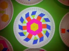 colorful paper plates with designs on them are arranged in the shape of a flower or star