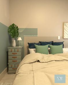 a bedroom with a bed, dresser and plant on the nightstands next to it