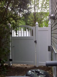 an outside view of a house with a white fence