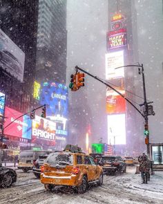 traffic lights and cars on a snowy day in times square, new york's financial district