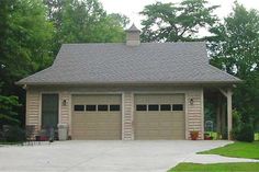 a two car garage with an attached porch