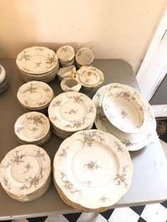 a table topped with lots of plates and bowls