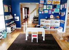 a living room with blue walls and wooden floors