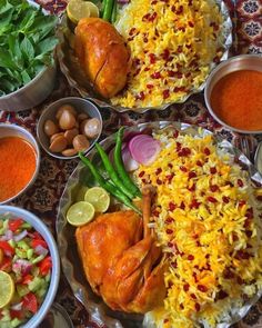 several bowls filled with food on top of a table covered in rice and sauces