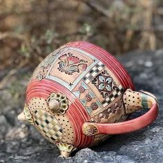 a ceramic turtle sitting on top of a rock