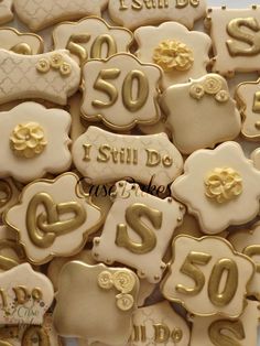 some very pretty decorated cookies with gold foiling on them for someone's 50th birthday