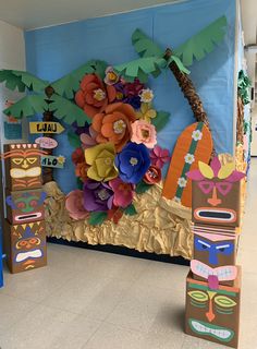 an art project with paper flowers and tiki masks on display in a classroom setting