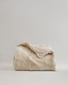 a white fur blanket on top of a table