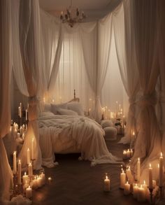 a bed with lots of candles on it in a room filled with white drapes and curtains