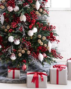 a christmas tree with presents under it