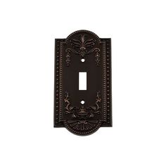 an ornate light switch plate cover in dark bronze finish with intricate designs on the front and back